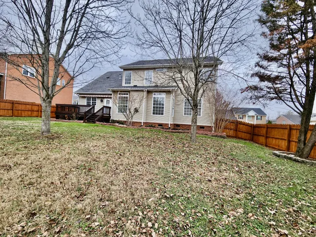 a view of a wooden deck with a yard