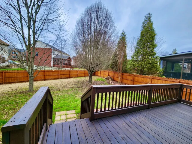 a view of a house with wooden deck