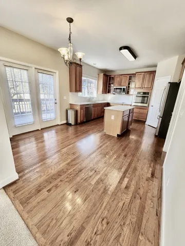 a living room with kitchen island furniture and a chandelier