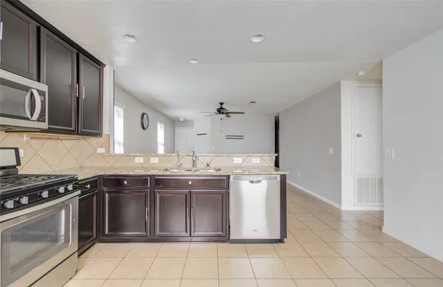 a kitchen with stainless steel appliances a stove sink and cabinets