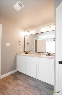 a bathroom with a sink and mirror