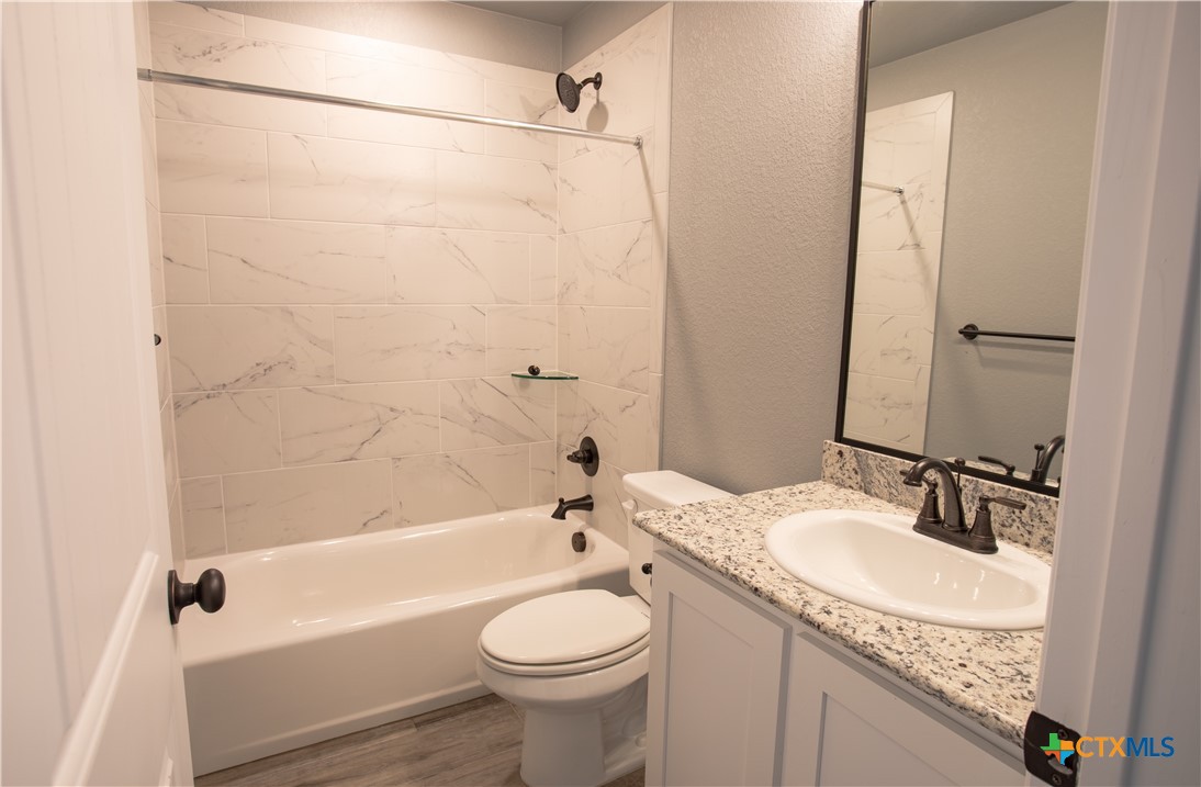3221 Digby Drive Belton, TX 76513 - Photo 20 of 30 a bathroom with a granite countertop sink toilet and shower