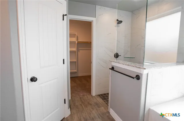 a bathroom with a shower and a sink