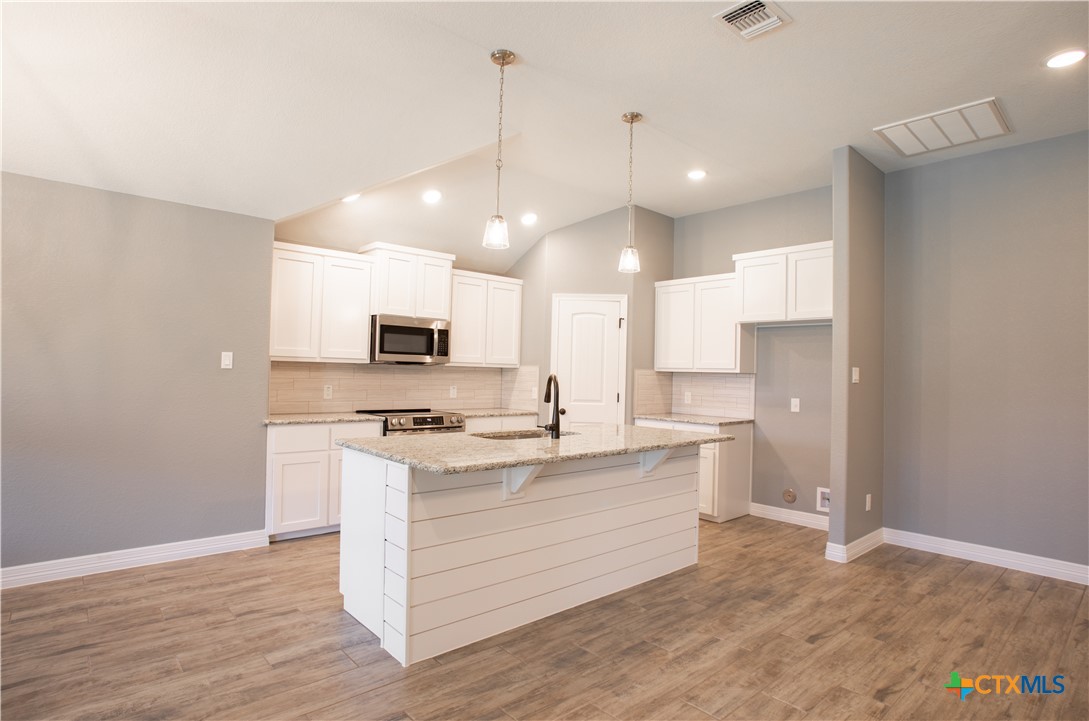 3221 Digby Drive Belton, TX 76513 - Photo 3 of 30 a kitchen with stainless steel appliances granite countertop a sink a stove and a refrigerator