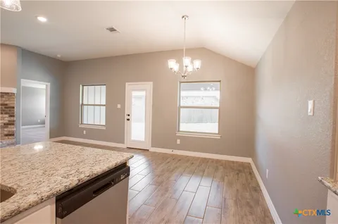 a view of a kitchen sink and natural light