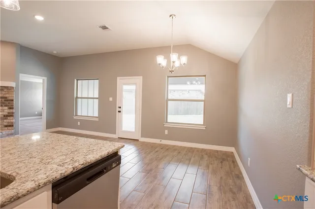 a view of a kitchen sink and natural light