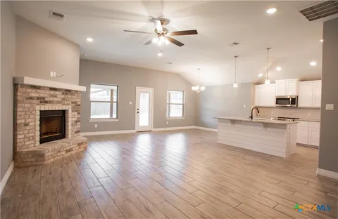 a view of kitchen with sink and wooden floor