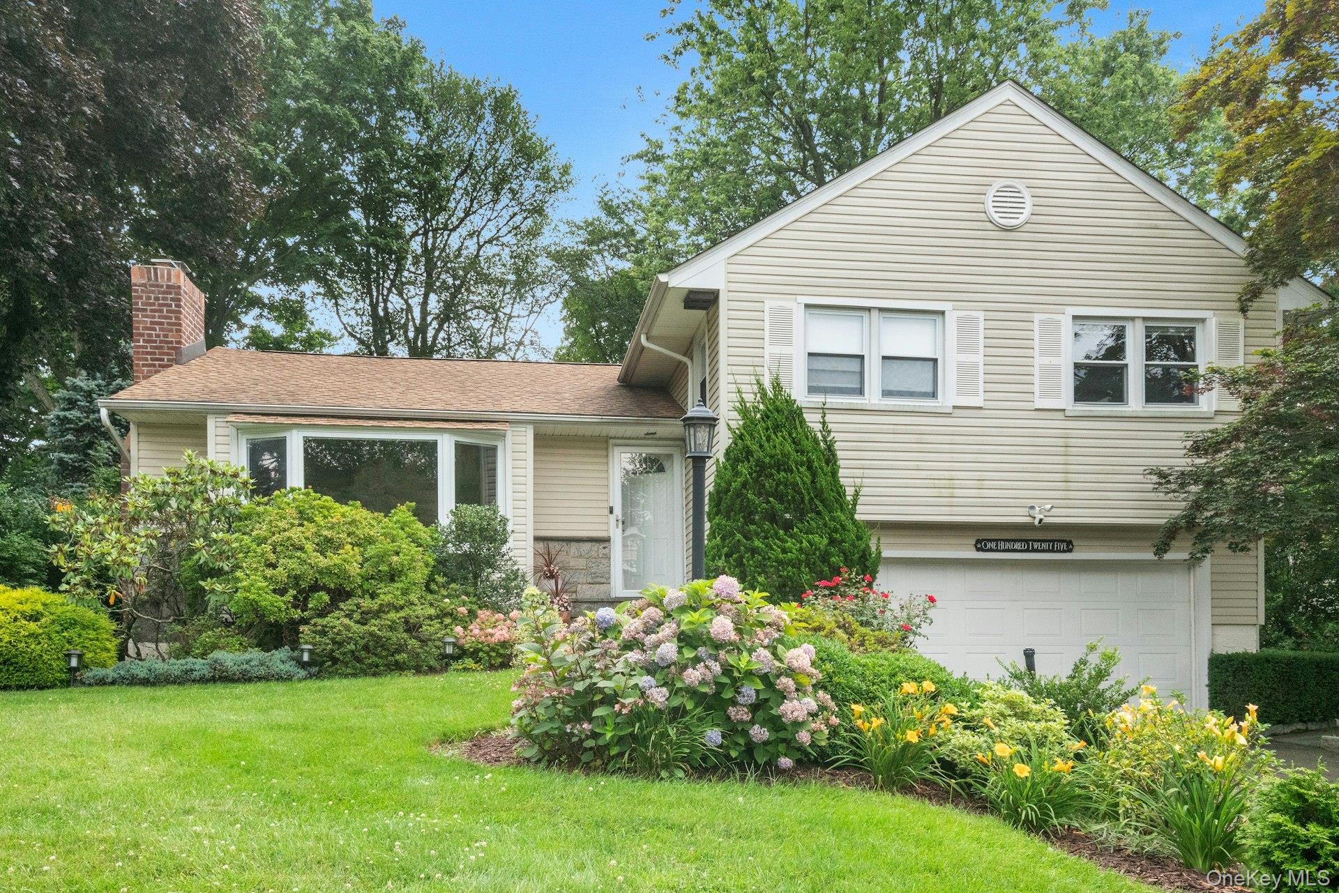 125 Darling Avenue New Rochelle, NY 10804 - Photo 1 of 1 a front view of a house with a garden