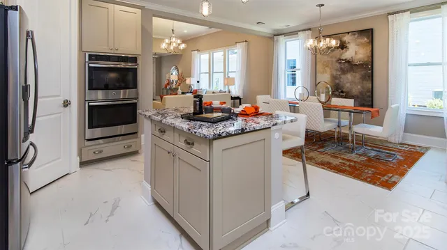 a kitchen with stainless steel appliances granite countertop a stove and a refrigerator