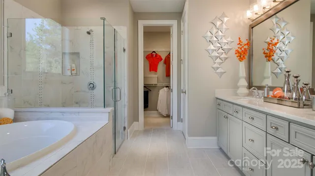 a bathroom with a granite countertop tub sink and mirror