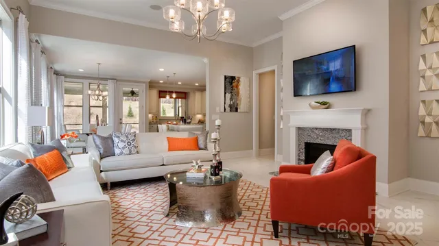 a living room with furniture a flat screen tv and a fireplace