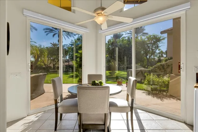a view of a dining room with furniture large windows and wooden floor