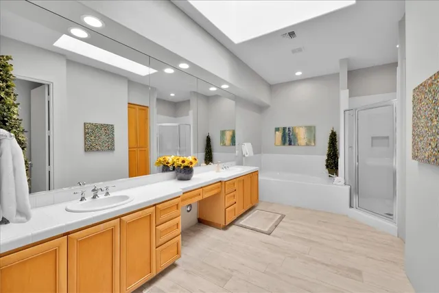 a bathroom with a tub a sink and shower