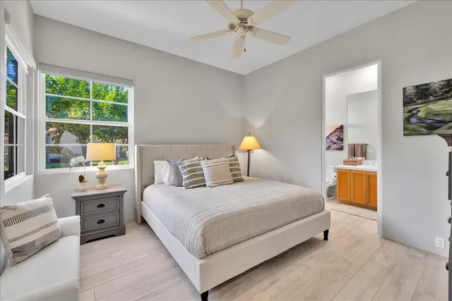 a bedroom with a bed a lamp and a chandelier