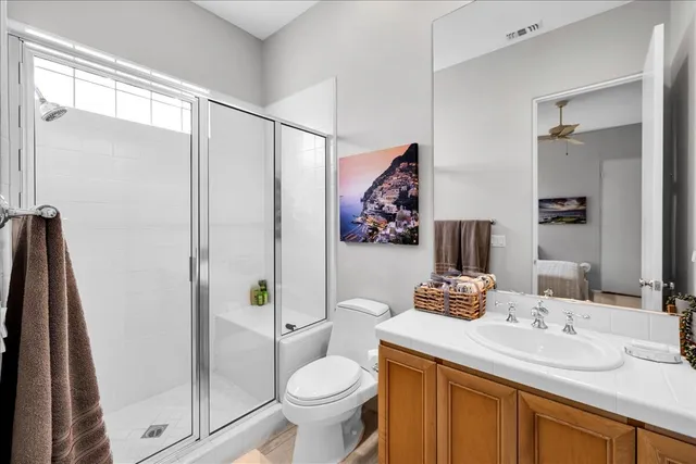 a bathroom with a granite countertop sink toilet and a mirror
