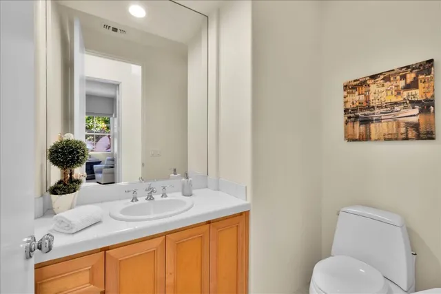 a view of a patio with couches table and chairs under an umbrella