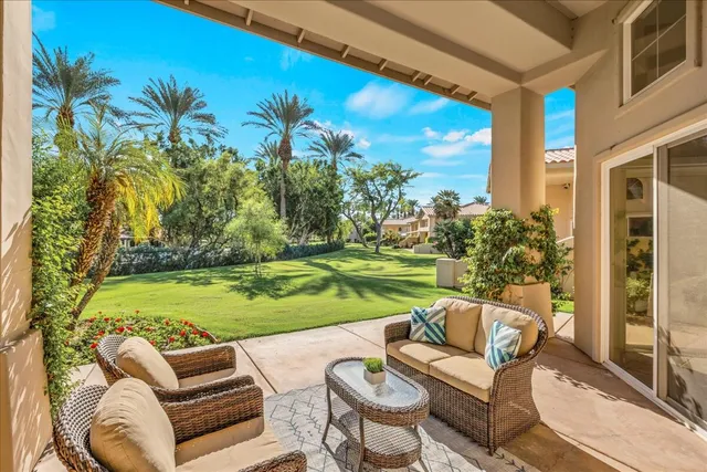 a view of a balcony with chair and potted plants