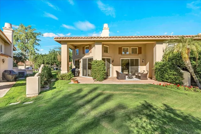 a view of a house with a backyard