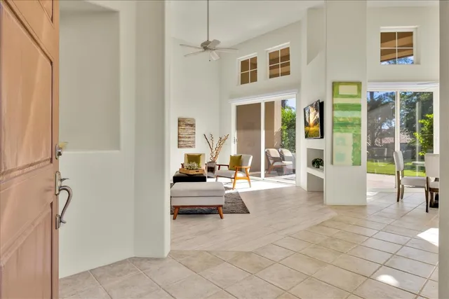 a living room with furniture and large windows