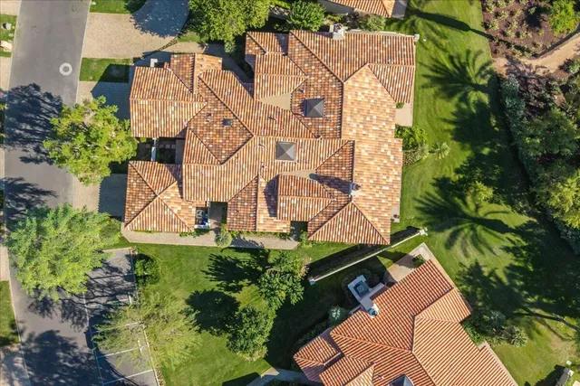 an aerial view of a house with a yard