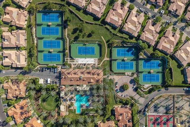 a front view of multi story residential apartment building with yard and sign board