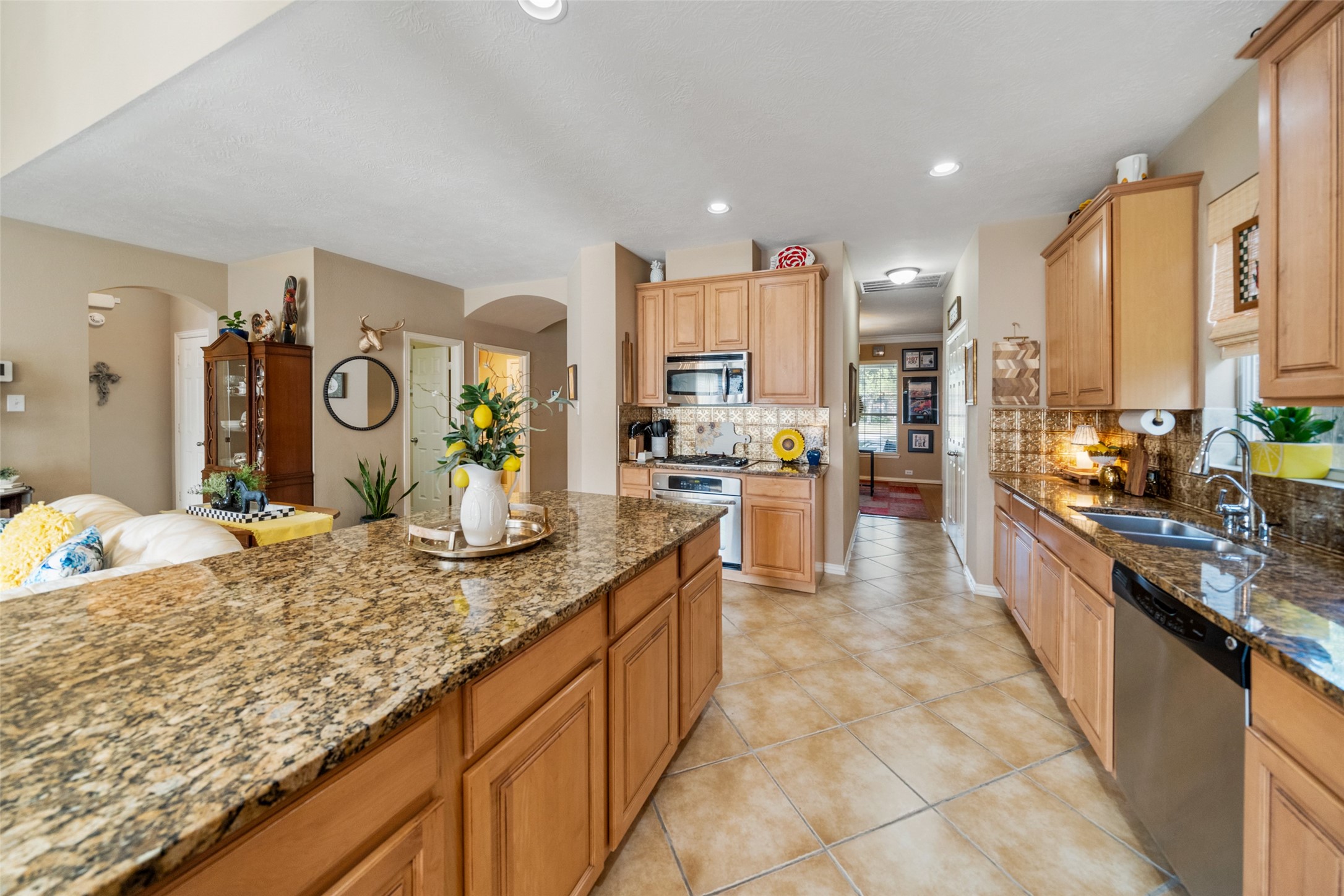 14422 Andrews Ridge Lane Humble, TX 77396 - Photo 17 of 40 a large kitchen with kitchen island granite countertop a large counter top and sink