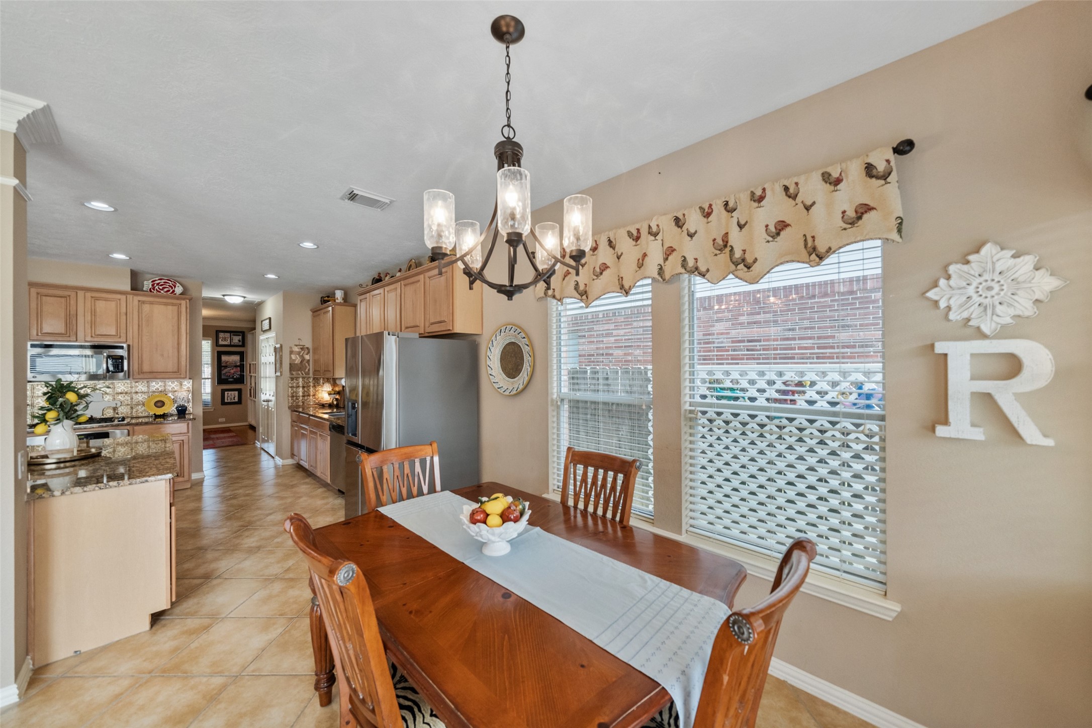 14422 Andrews Ridge Lane Humble, TX 77396 - Photo 20 of 40 a view of a dining room with furniture and chandelier