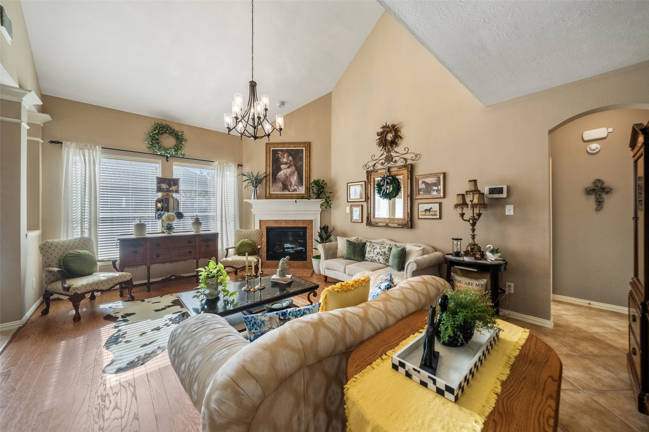 14422 Andrews Ridge Lane Humble, TX 77396 - Photo 21 of 40 a living room with furniture a fireplace and a chandelier