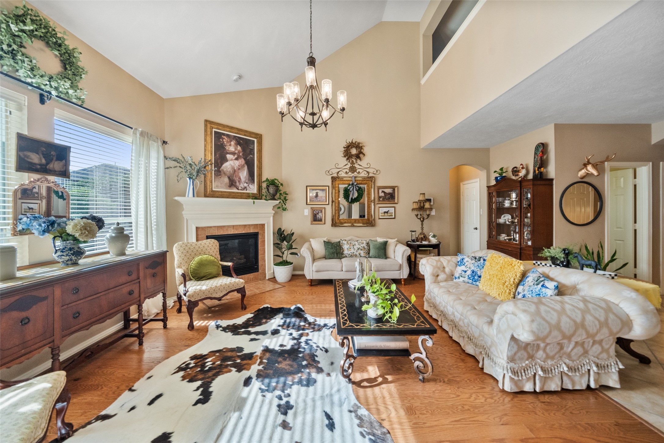 14422 Andrews Ridge Lane Humble, TX 77396 - Photo 24 of 40 a living room with furniture a fireplace and a chandelier