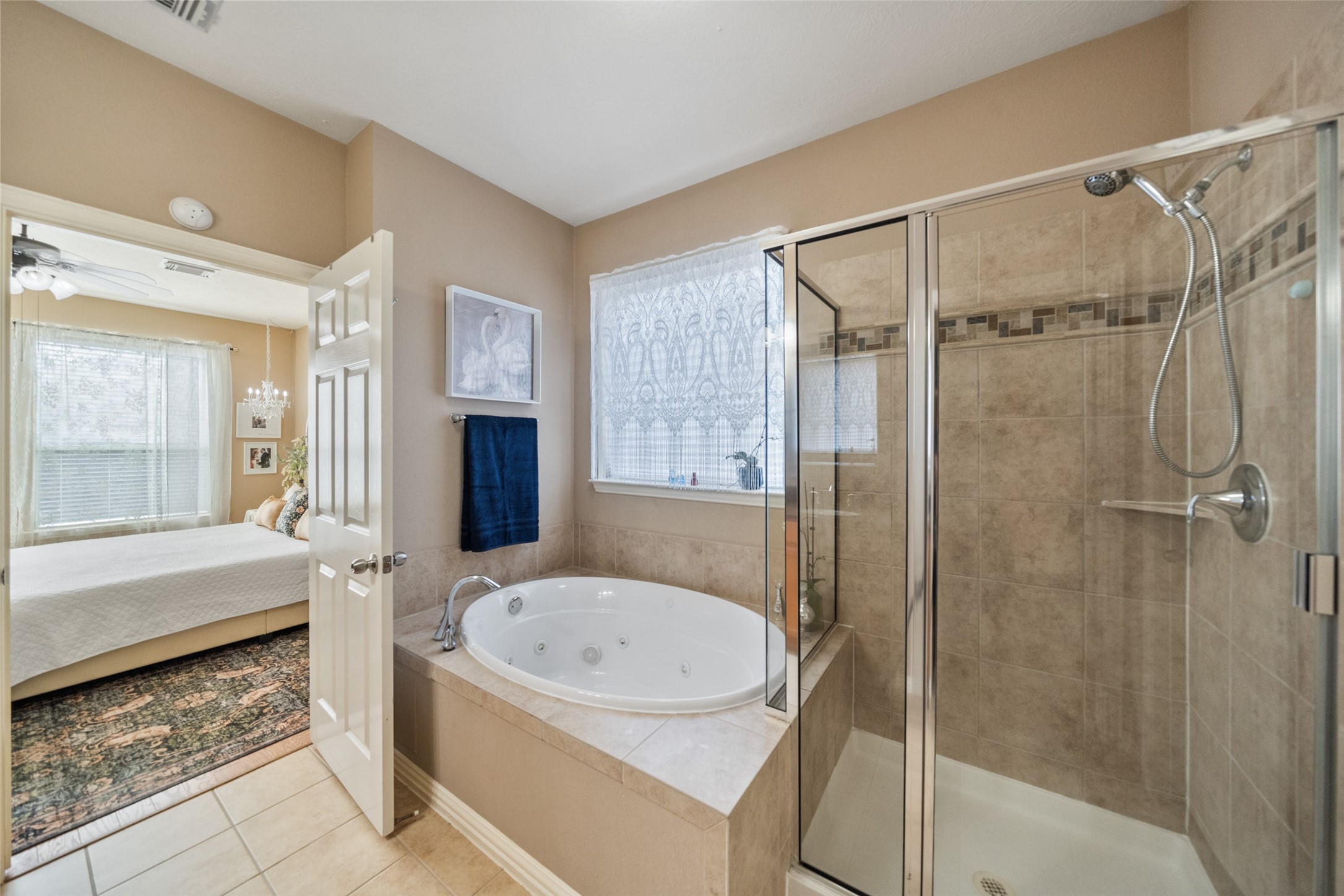 14422 Andrews Ridge Lane Humble, TX 77396 - Photo 26 of 40 a bathroom with a tub shower and mirror