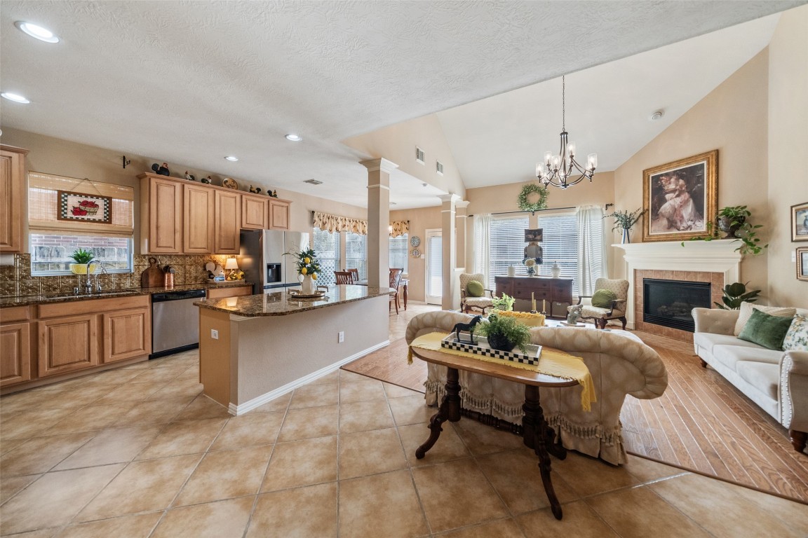 14422 Andrews Ridge Lane Humble, TX 77396 - Photo 3 of 40 a living room with fireplace furniture and a kitchen view