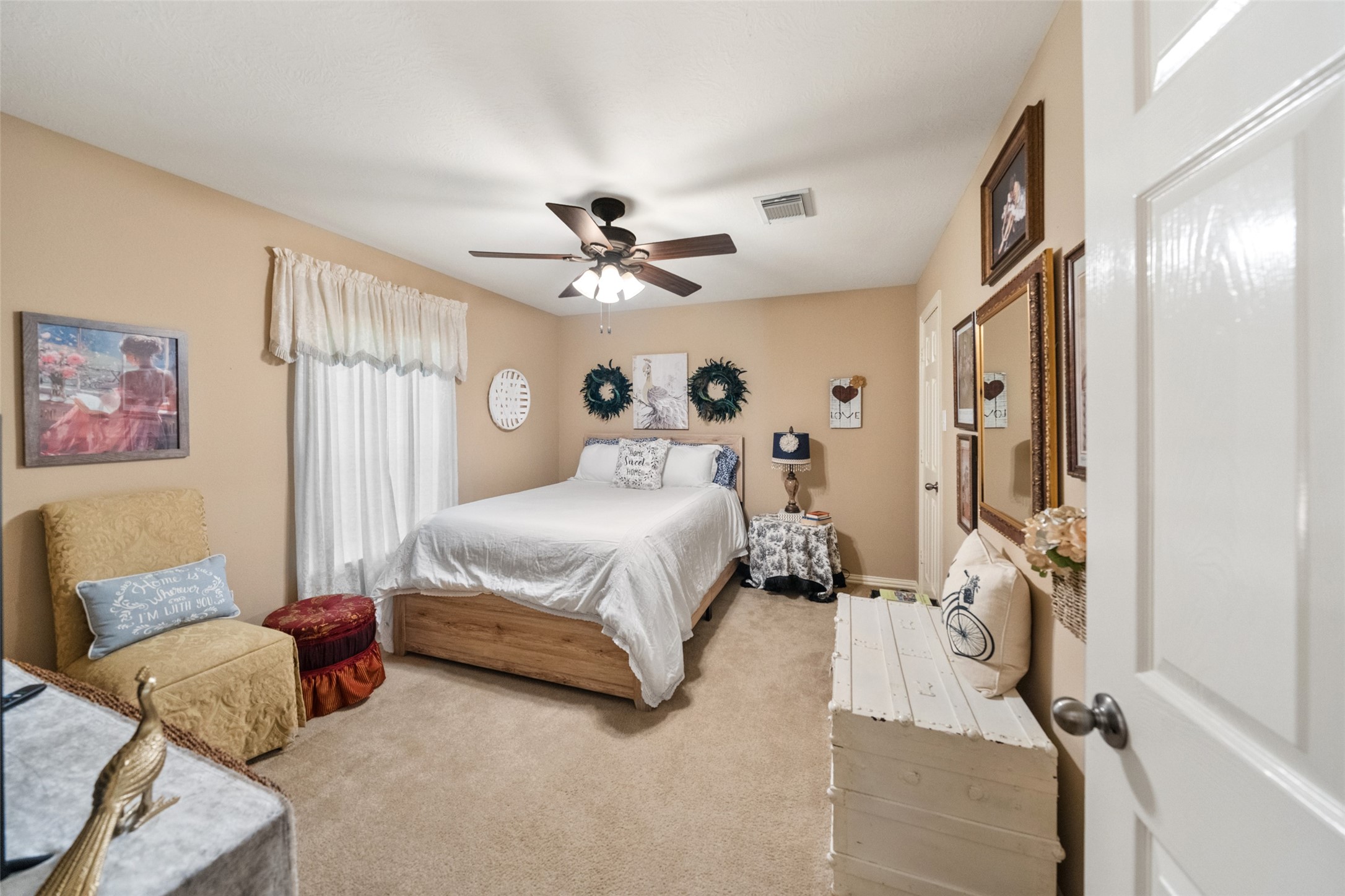 14422 Andrews Ridge Lane Humble, TX 77396 - Photo 31 of 40 a spacious bedroom with a bed couch chandelier and a window