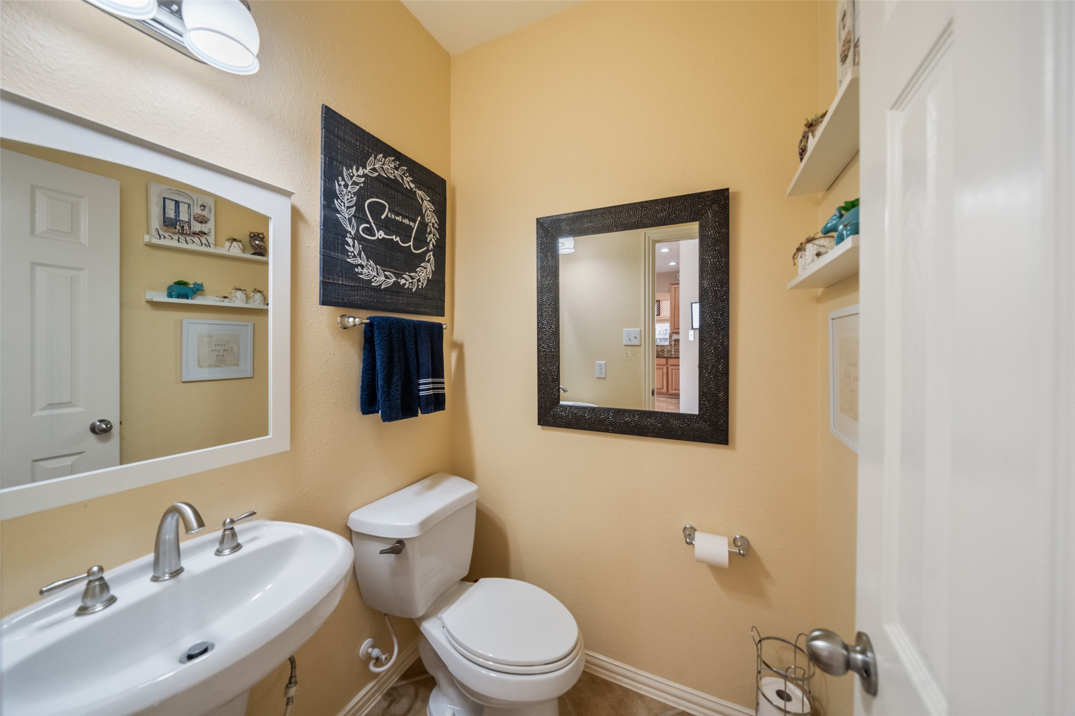 14422 Andrews Ridge Lane Humble, TX 77396 - Photo 34 of 40 a bathroom with a toilet sink and mirror