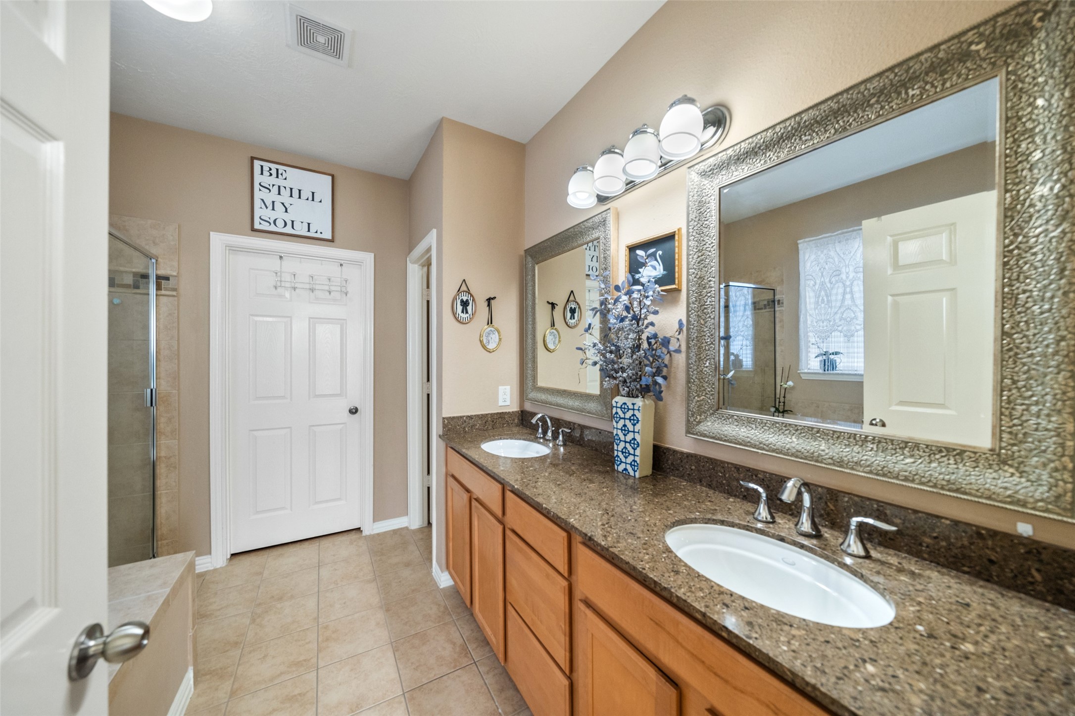 14422 Andrews Ridge Lane Humble, TX 77396 - Photo 6 of 40 a bathroom with a granite countertop sink a mirror and a shower