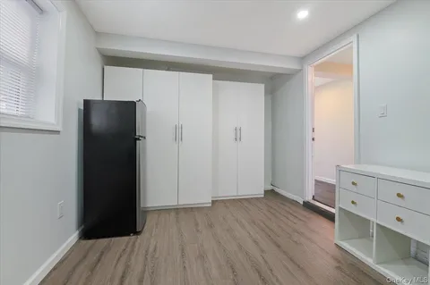 a view of walk in closet with wooden floor