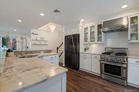 a kitchen with a stove a refrigerator and a sink