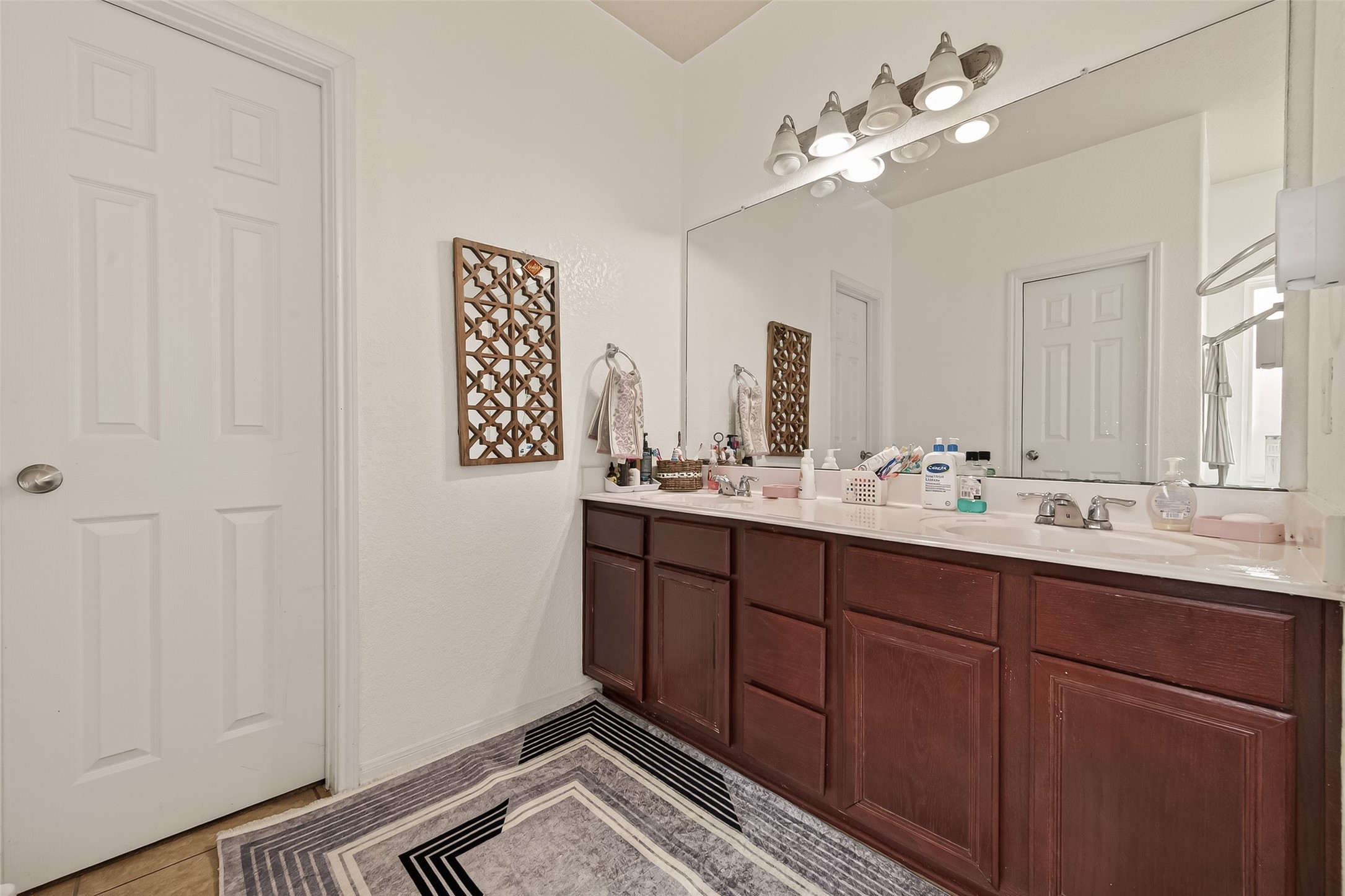 18303 All Oak Trail Houston, TX 77084 - Photo 15 of 31 a bathroom with a double vanity sink and a mirror