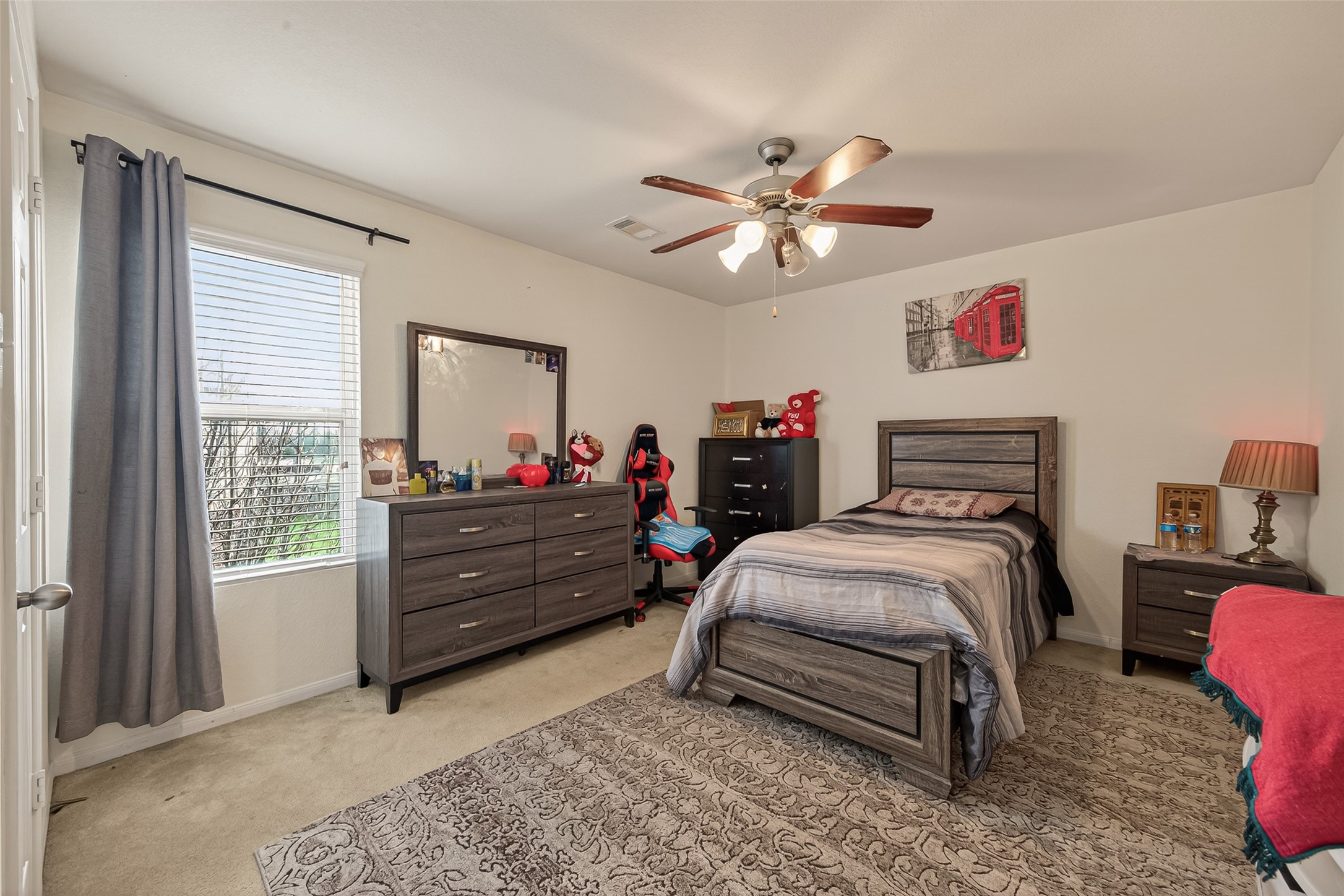 18303 All Oak Trail Houston, TX 77084 - Photo 19 of 31 a bedroom with a bed and a chandelier