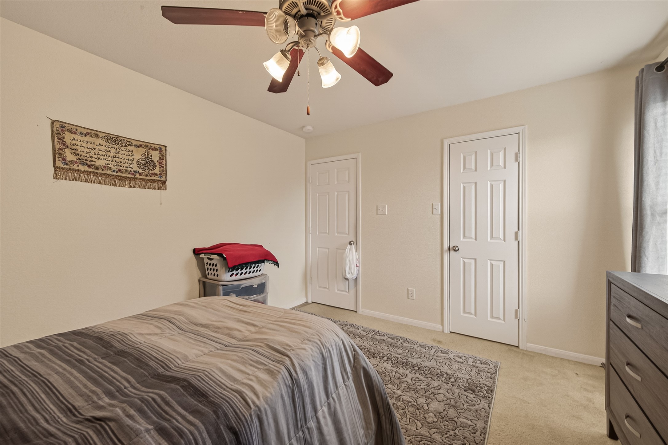 18303 All Oak Trail Houston, TX 77084 - Photo 20 of 31 a bedroom with a bed and a chandelier