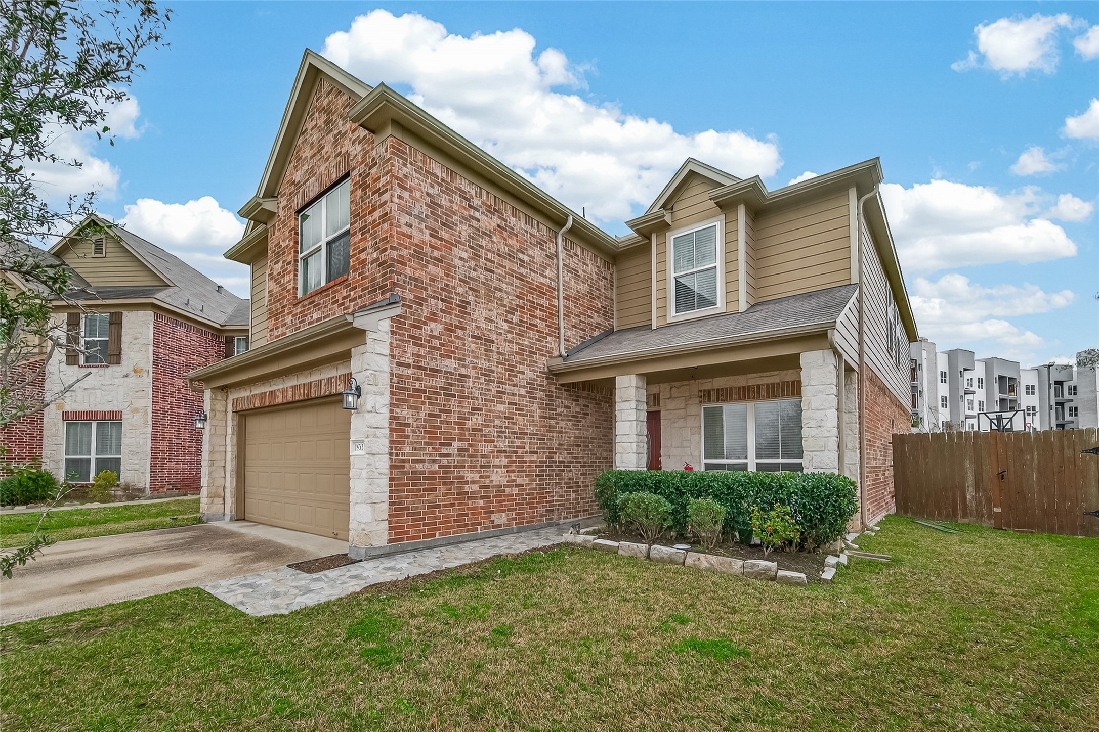 18303 All Oak Trail Houston, TX 77084 - Photo 2 of 31 a front view of a house with a yard and garage