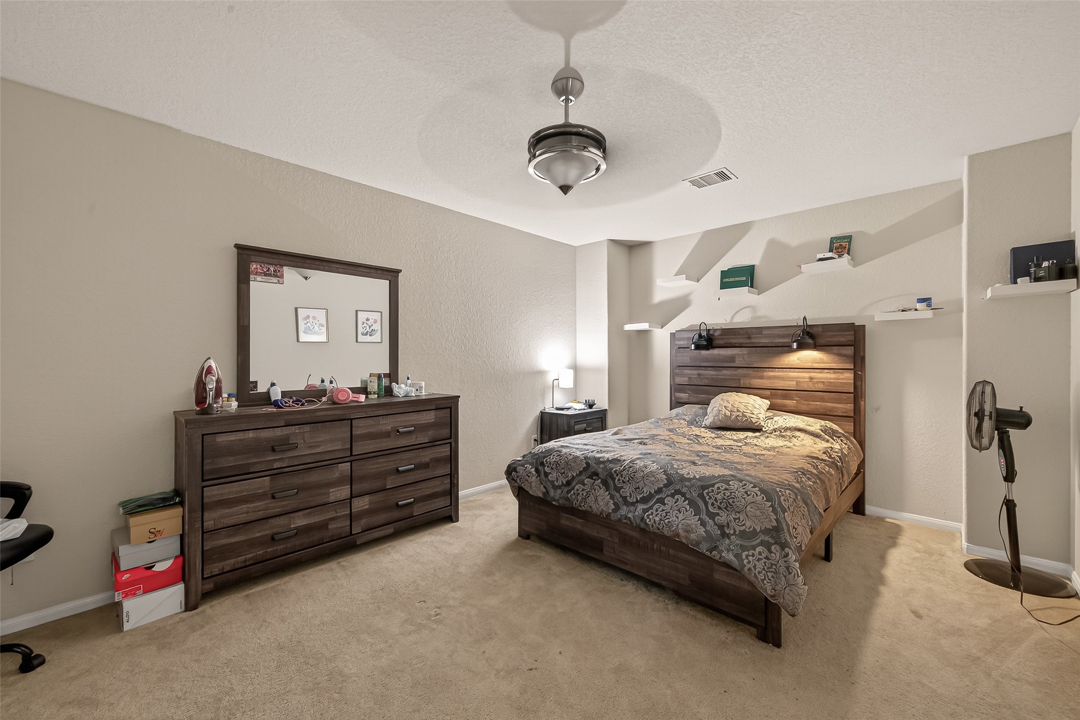 18303 All Oak Trail Houston, TX 77084 - Photo 27 of 31 a bedroom with a bed and a chandelier