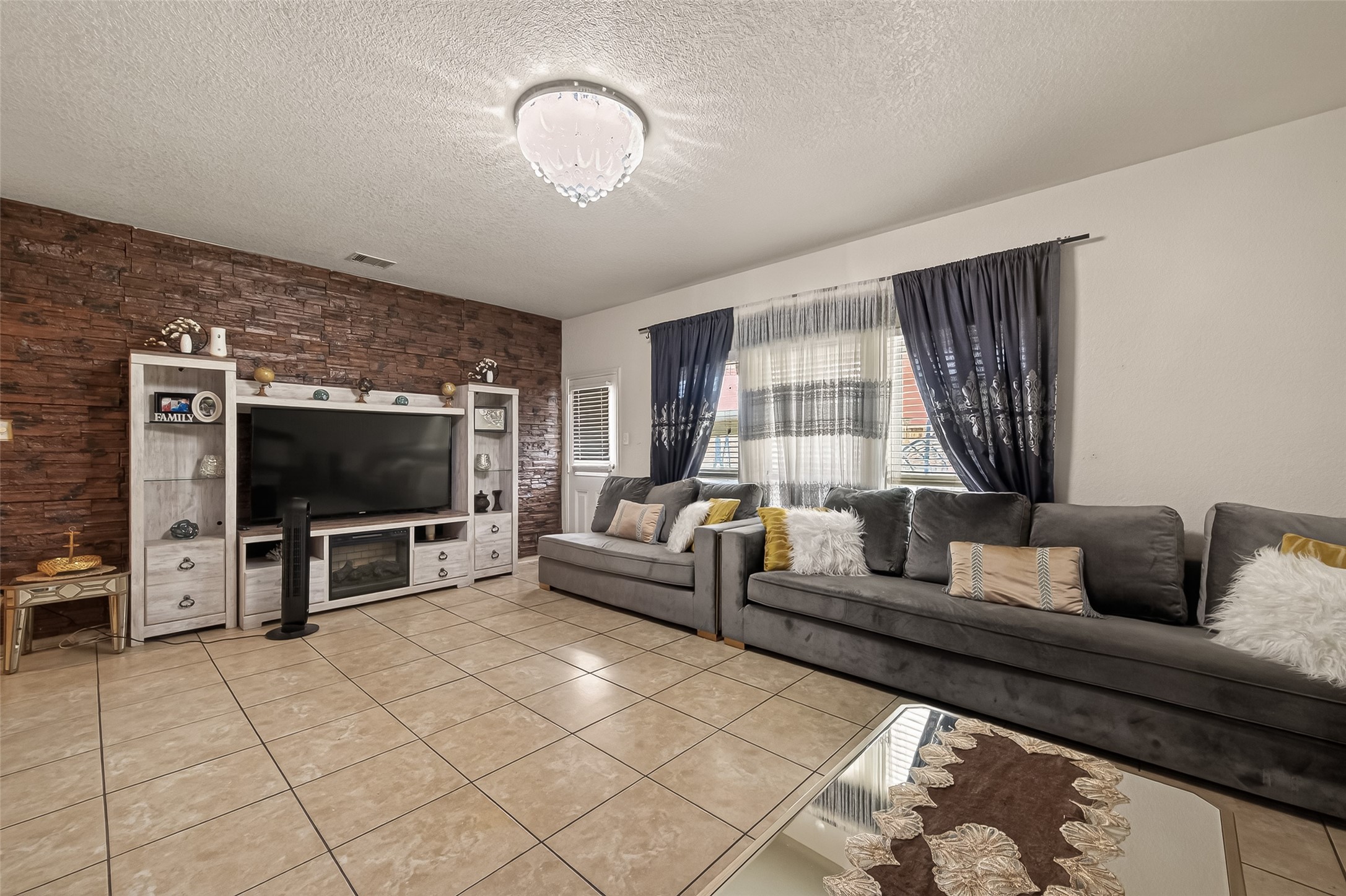 18303 All Oak Trail Houston, TX 77084 - Photo 7 of 31 a living room with furniture and a flat screen tv