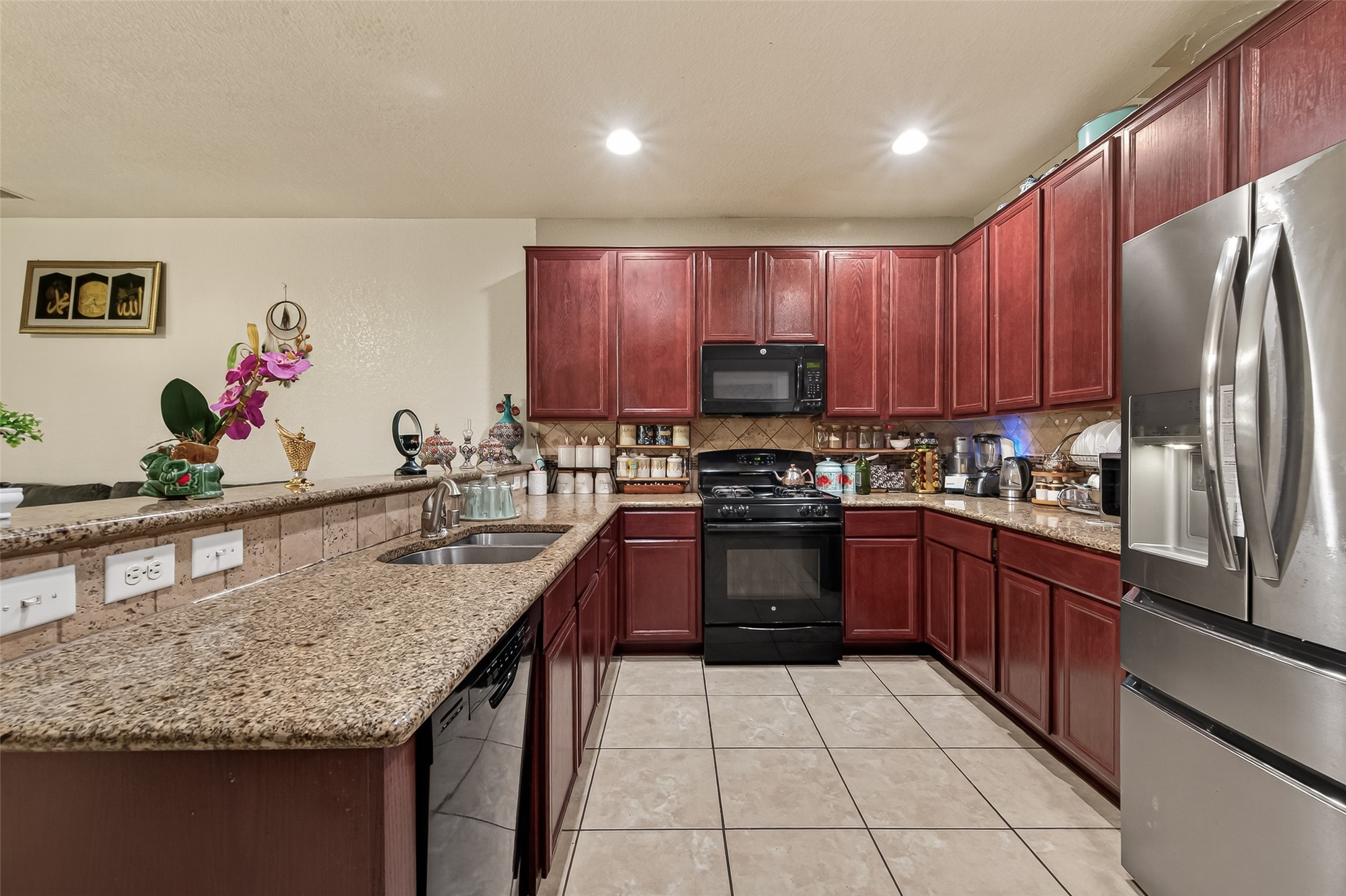 18303 All Oak Trail Houston, TX 77084 - Photo 9 of 31 a kitchen with stainless steel appliances granite countertop a sink stove and refrigerator