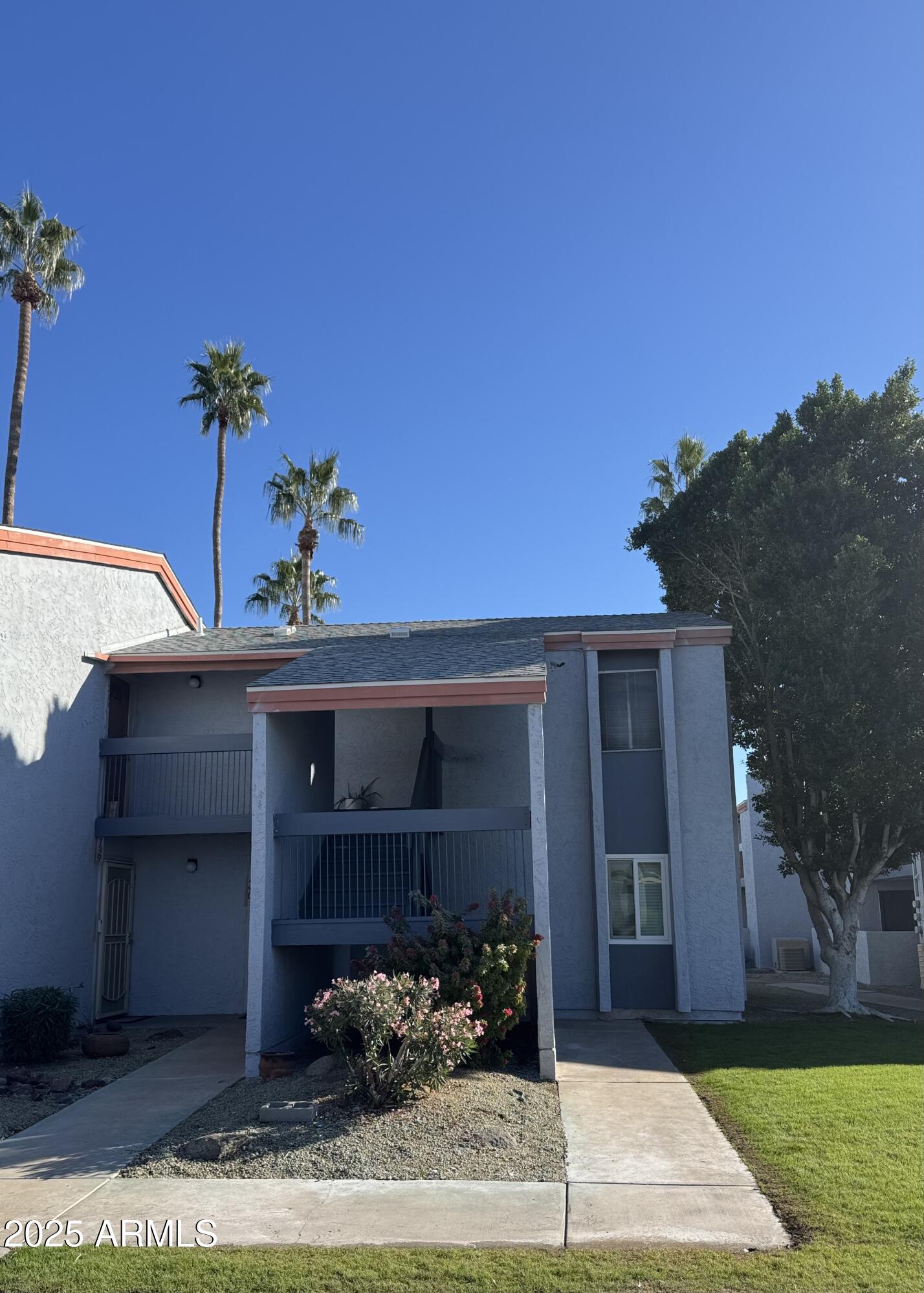 7550 North 12th Street, Unit 239 Phoenix, AZ 85020 - Photo 1 of 14 a front view of a house with a yard