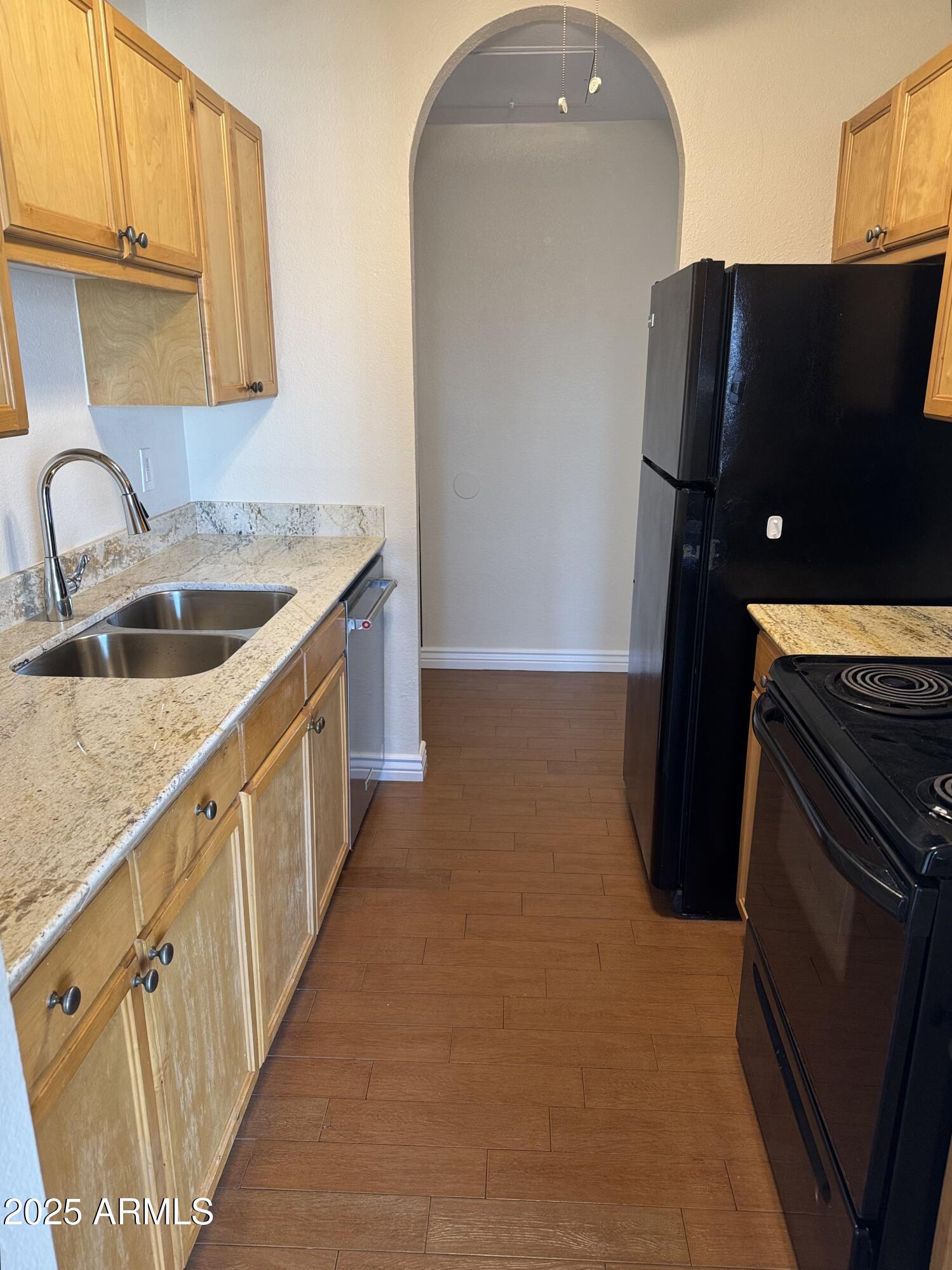 7550 North 12th Street, Unit 239 Phoenix, AZ 85020 - Photo 4 of 14 a kitchen with granite countertop a sink and a refrigerator