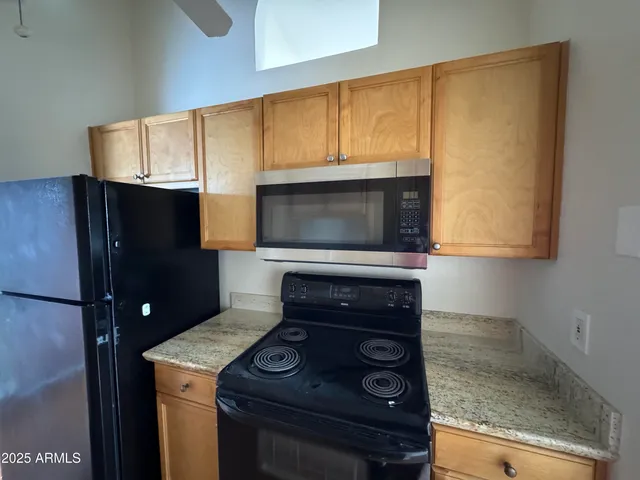 a kitchen with a stove microwave and sink