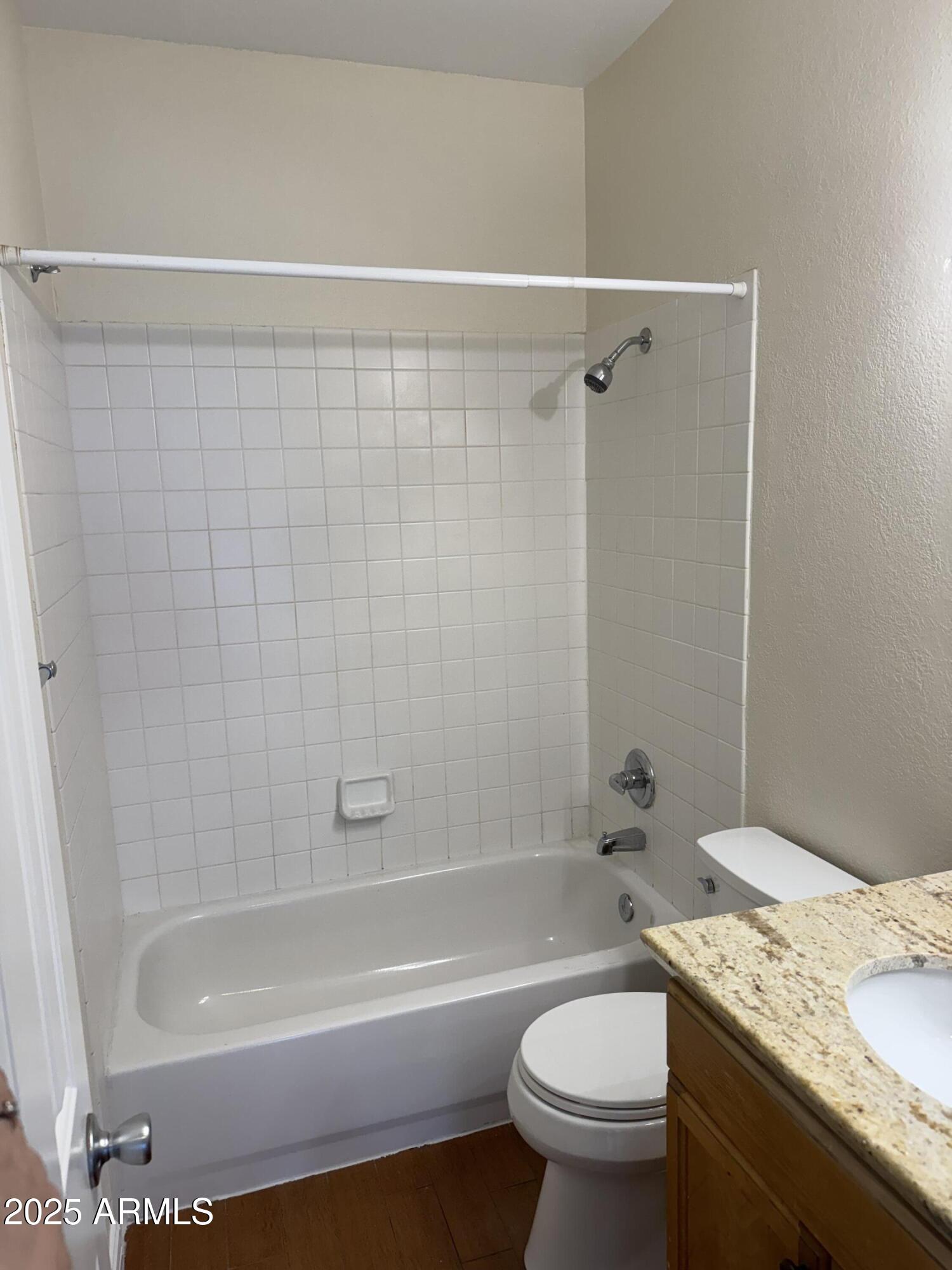 7550 North 12th Street, Unit 239 Phoenix, AZ 85020 - Photo 7 of 14 a bathroom with a granite countertop toilet a sink and bathtub