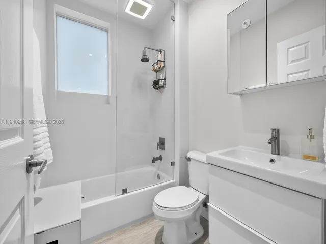 a bathroom with a sink toilet and shower