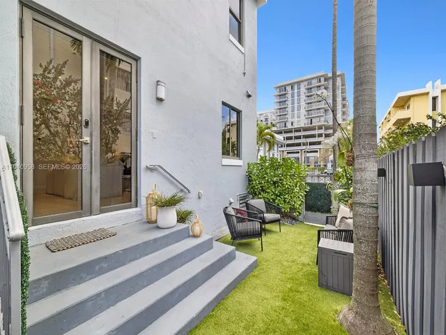 a bedroom with furniture and a potted plant