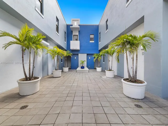 a view of a street with potted plants
